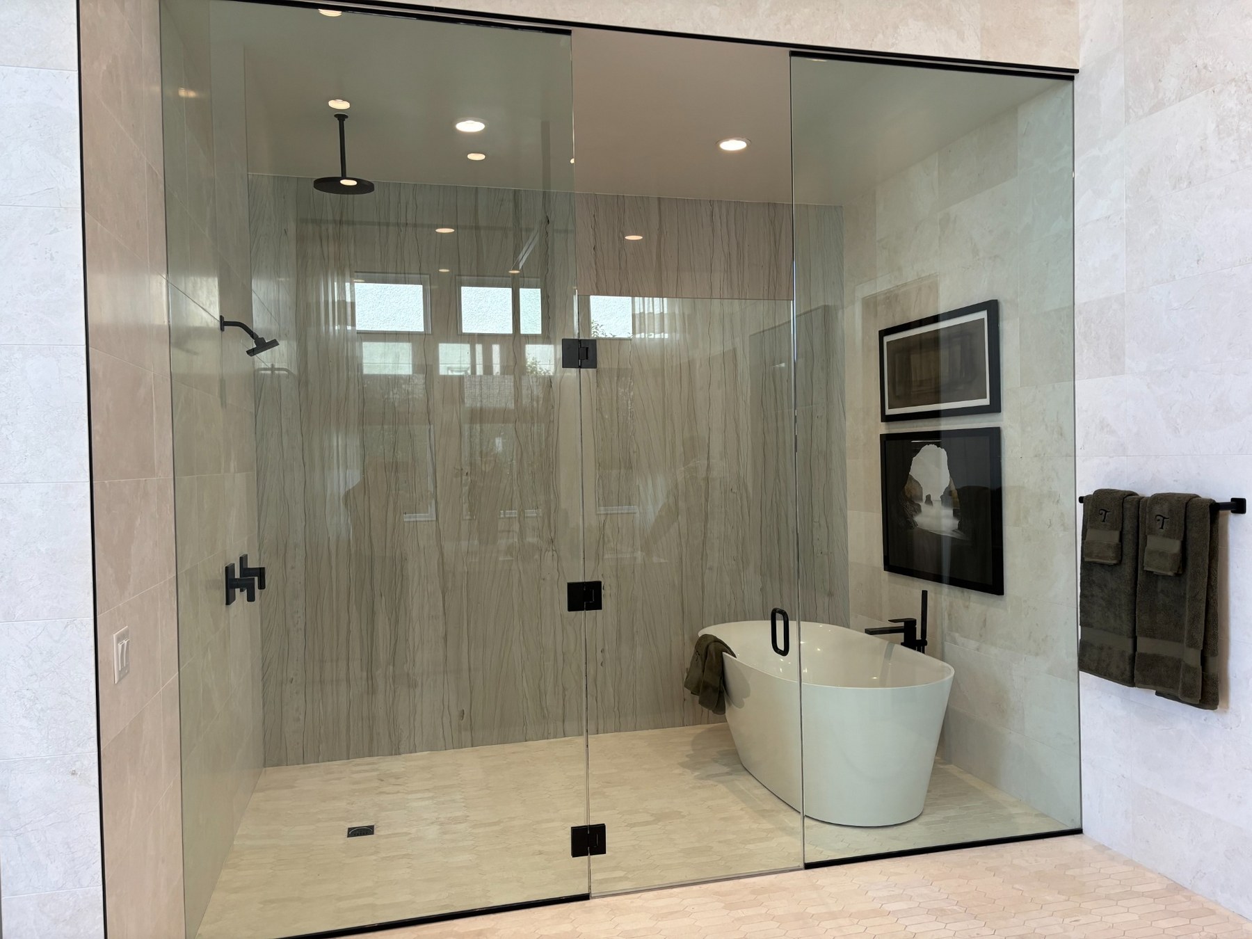 Bathroom after MSWT remodel — frameless glass shower and freestanding tub